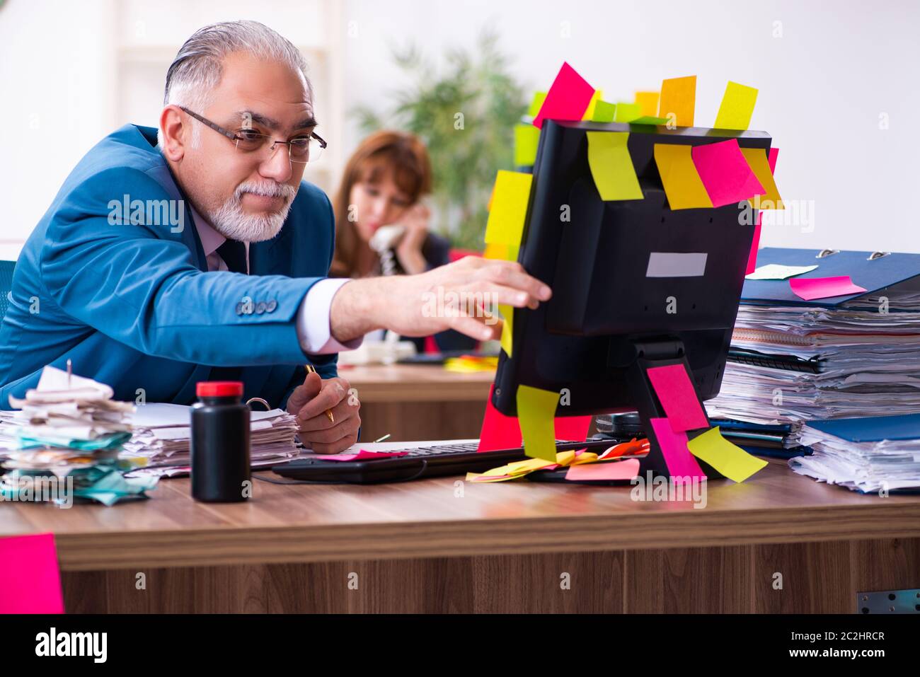 Two employees and excessive work in office Stock Photo