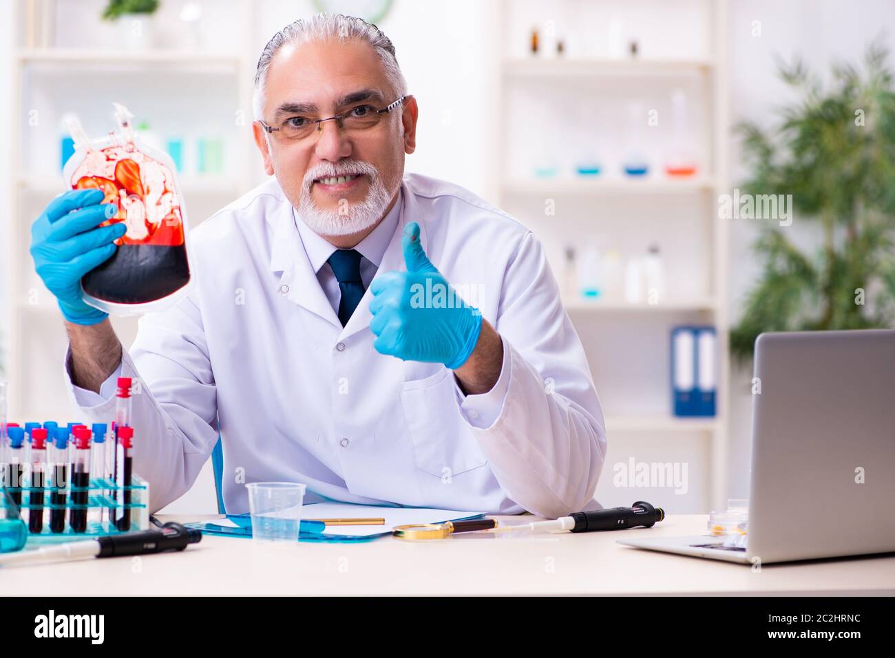 Old chemist working in the lab Stock Photo
