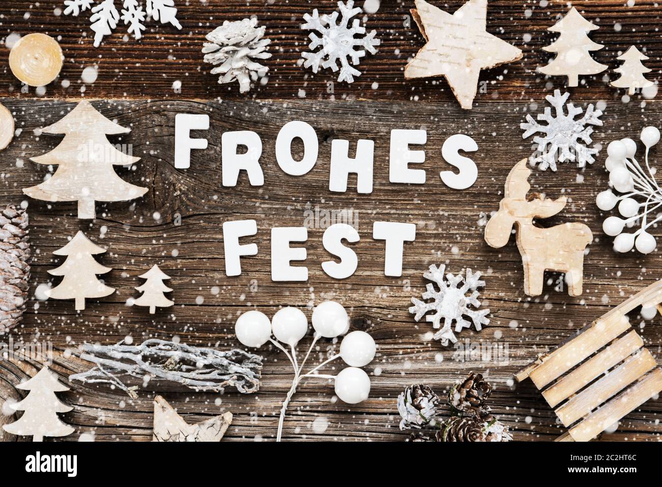 White Letters Building The Word Frohes Fest Means Merry Christmas. Wooden Christmas Decoration Like Sled And Tree And Star. Brown Wooden Background Wi Stock Photo