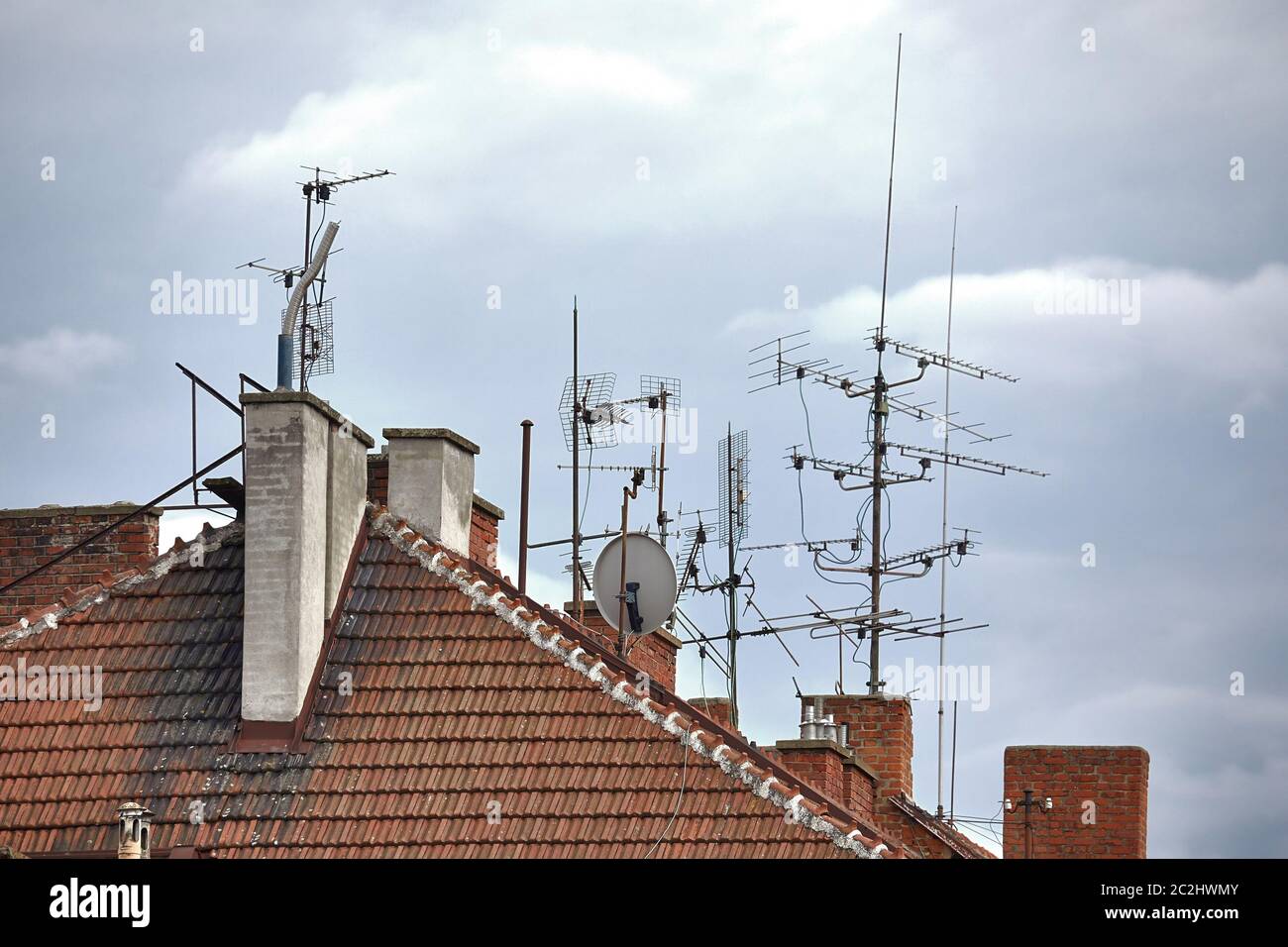 Antennas on an old urban rooftop Stock Photo - Alamy