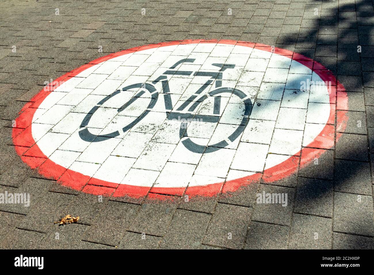 Bicycling prohibited sign on sidewalk in detail Stock Photo - Alamy