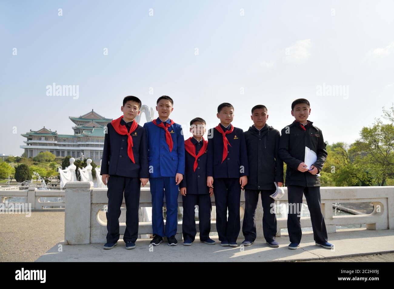 Pyongyang, North Korea - April 29, 2019: Young boys, members of the Korean Children's Union KCU, Young Pioneer Corps, on a city street Stock Photo