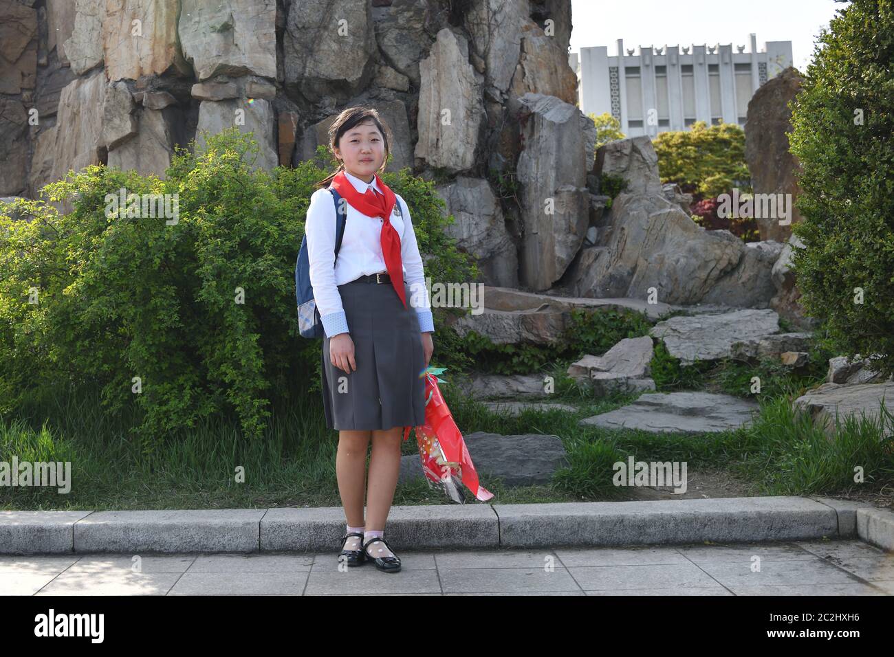 Pyongyang, North Korea - April 29, 2019: Young girl, member of the Korean Children's Union KCU, Young Pioneer Corps, on a city street Stock Photo