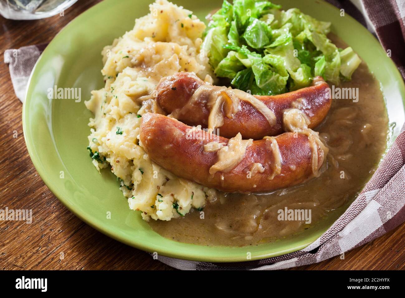 Bangers and Mash. Baked sausage in onion gravy served with mashed
