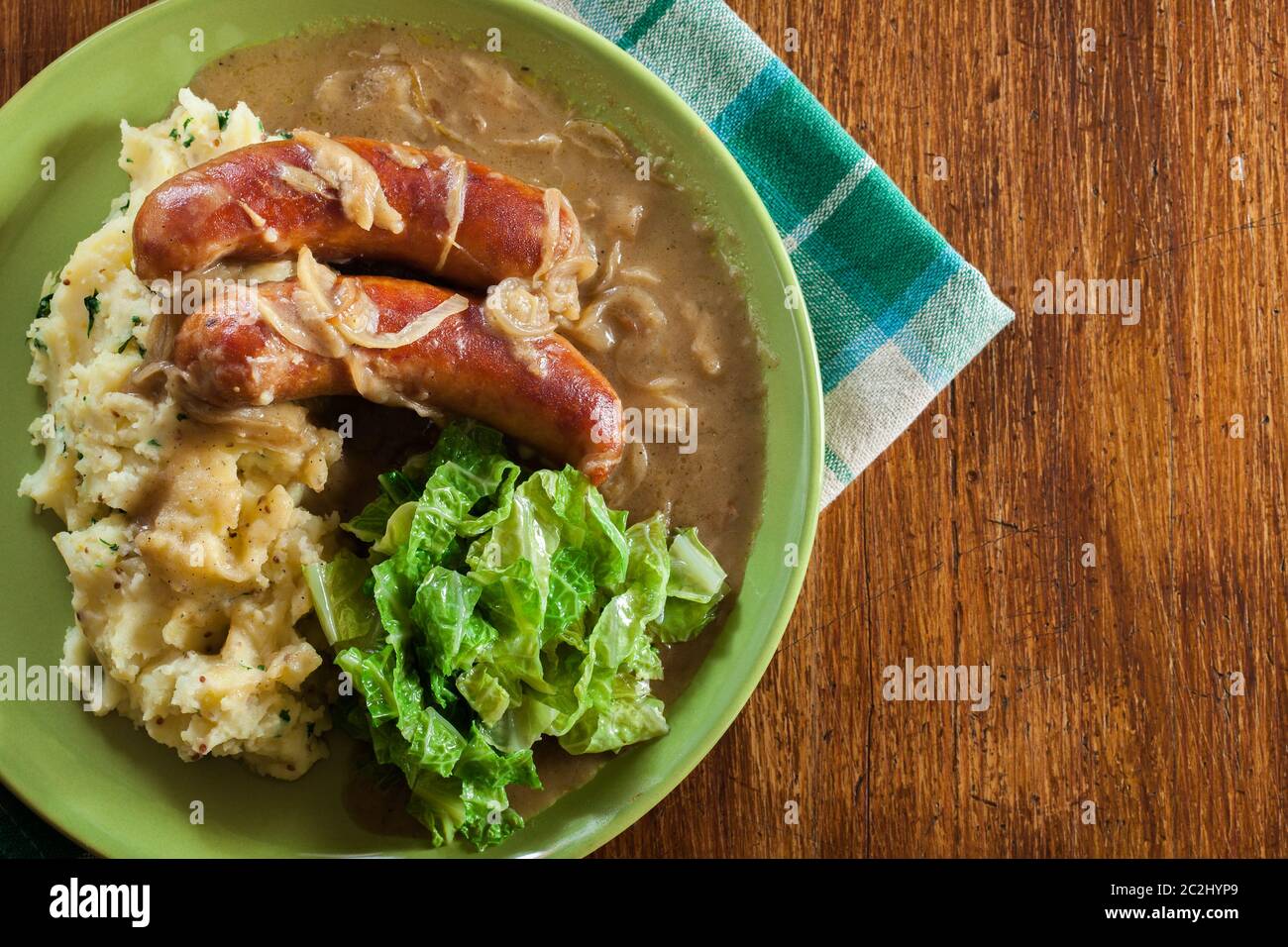 Bangers and Mash. Baked sausage in onion gravy served with mashed