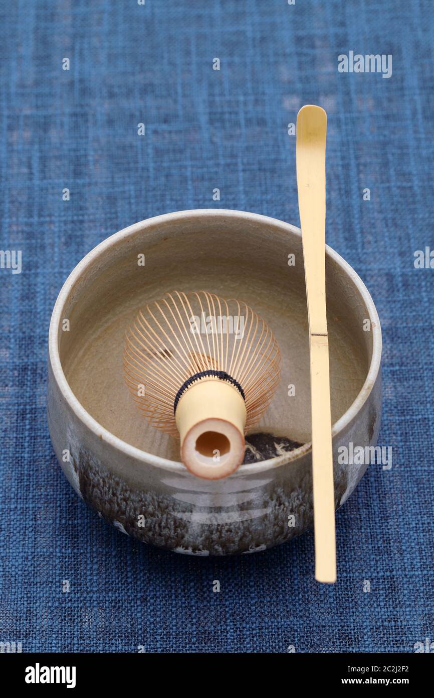Tea bowl with tea whisk and bamboo spoon used in Japanese matcha green tea ceremony Stock Photo