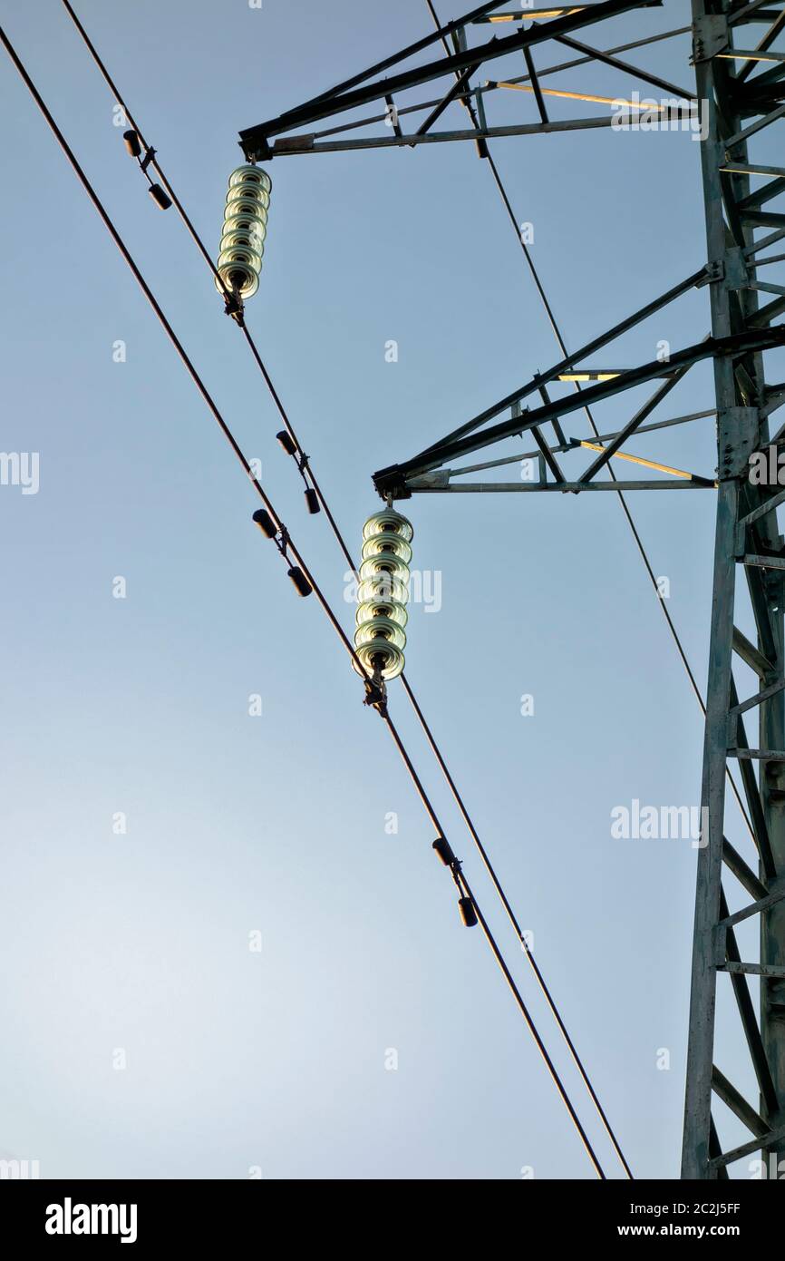 High voltage power lines and green insulators Stock Photo