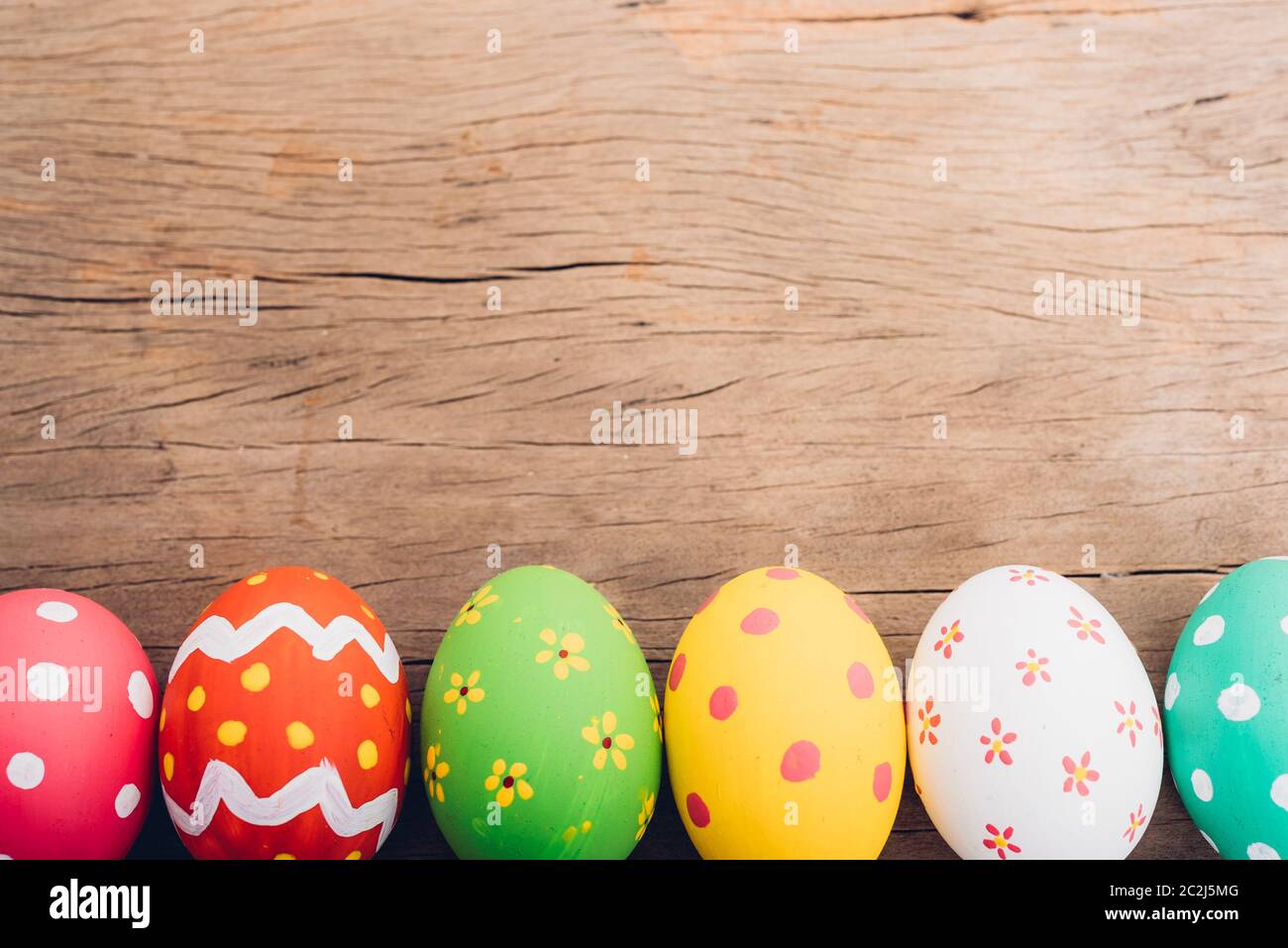 Beautiful Easter multi color egg on wooden background, Easter day concept Stock Photo