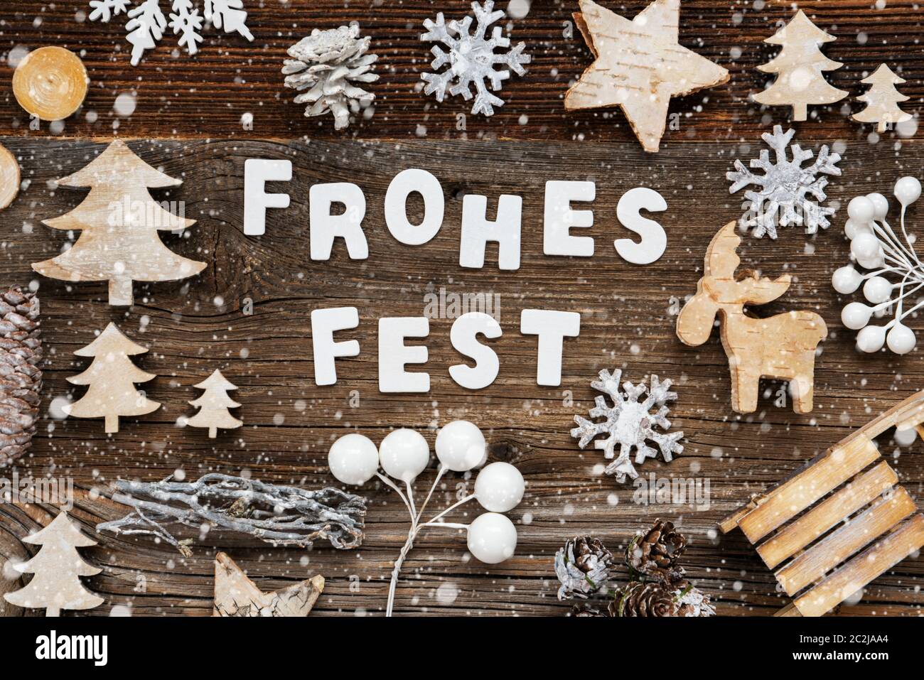 White Letters Building The Word Frohes Fest Means Merry Christmas. Wooden Christmas Decoration Like Tree, Sled And Star. Brown Wooden Background With Stock Photo