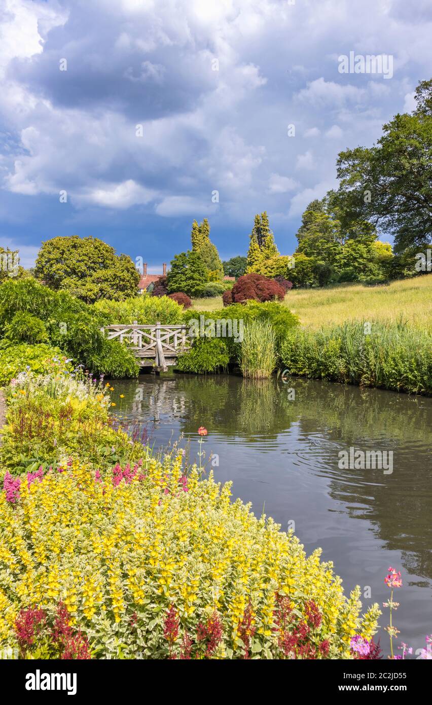View in RHS Garden Wisley of the stream and ponds between Oakwood and the Alpine Meadow and Rock Garden, in summer Stock Photo