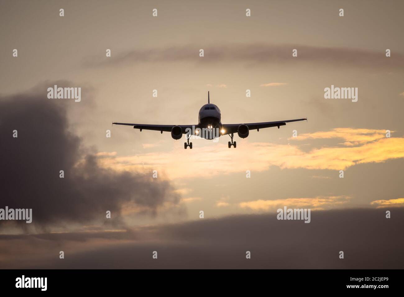 air plane in sunset sky Stock Photo