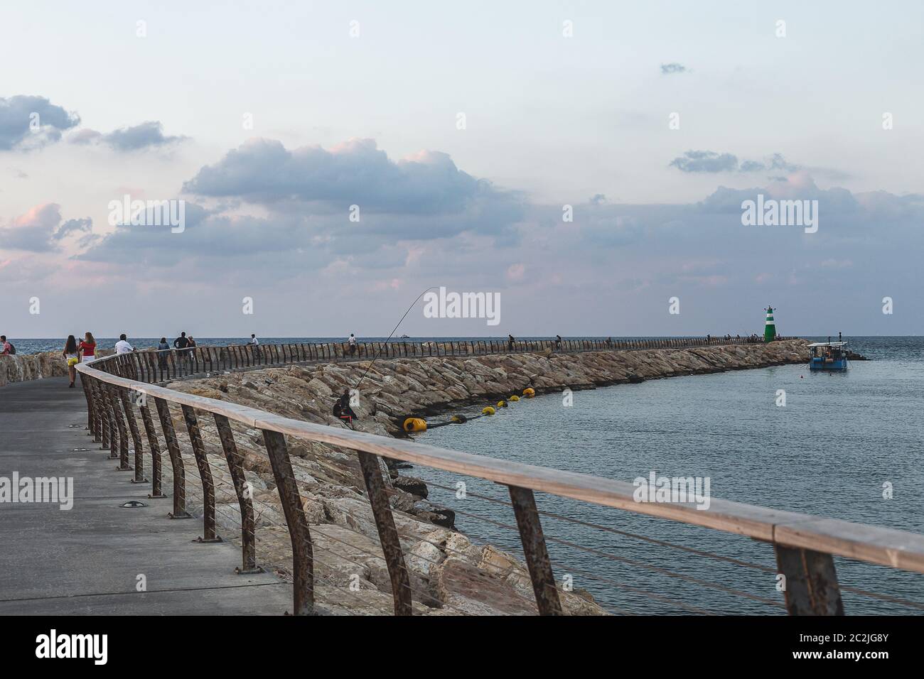 Tel Aviv/Israel-8/10/18: breakwater with the lighthouse on its end, forms Marina Tel-Aviv. Breakwaters are structures constructed to protect an anchor Stock Photo