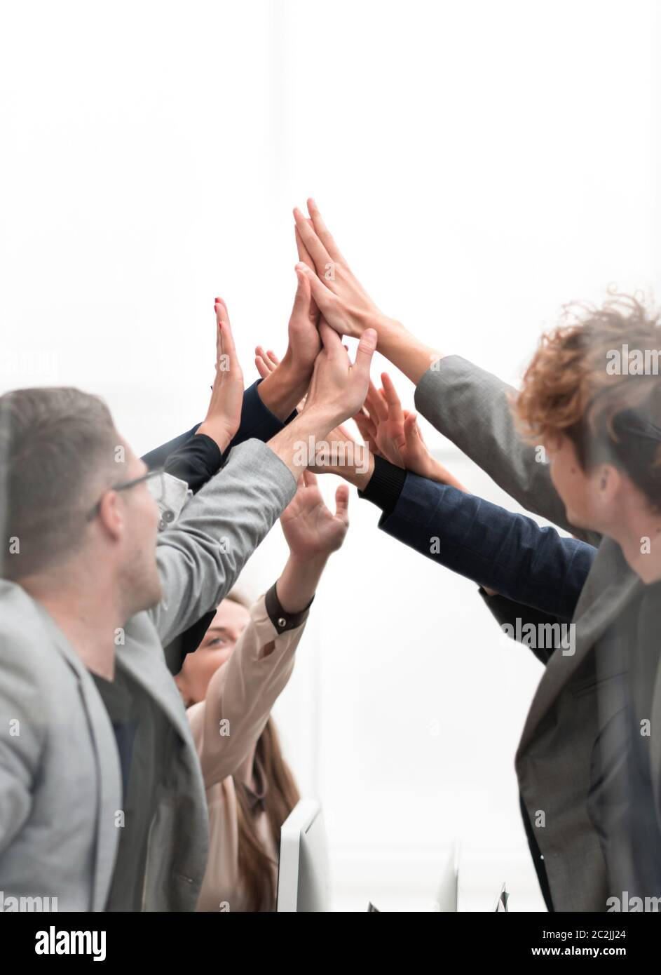 group of happy employees giving each other a high five Stock Photo - Alamy