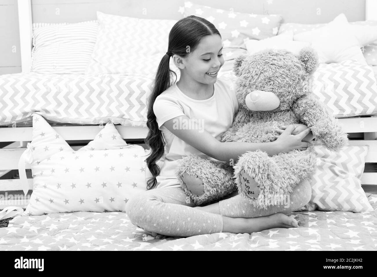 Favorite toy. Girl child hug teddy bear in her bedroom. Pleasant time