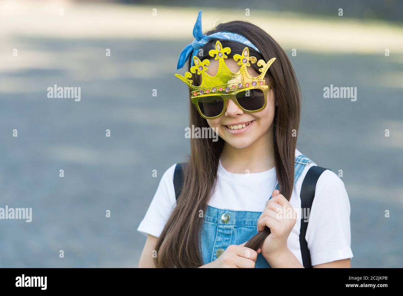 Live like you dream. Happy girl wear prop crown and glasses. Little miss beauty. Child beauty pageant crown. Party crown. Fashion accessories. Golden diadem or tiara. Big boss. Crown she deserves. Stock Photo