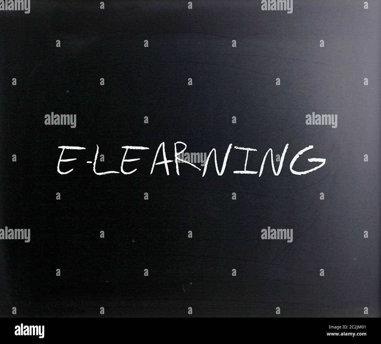 "E-learning" handwritten with white chalk on a blackboard. Stock Photo