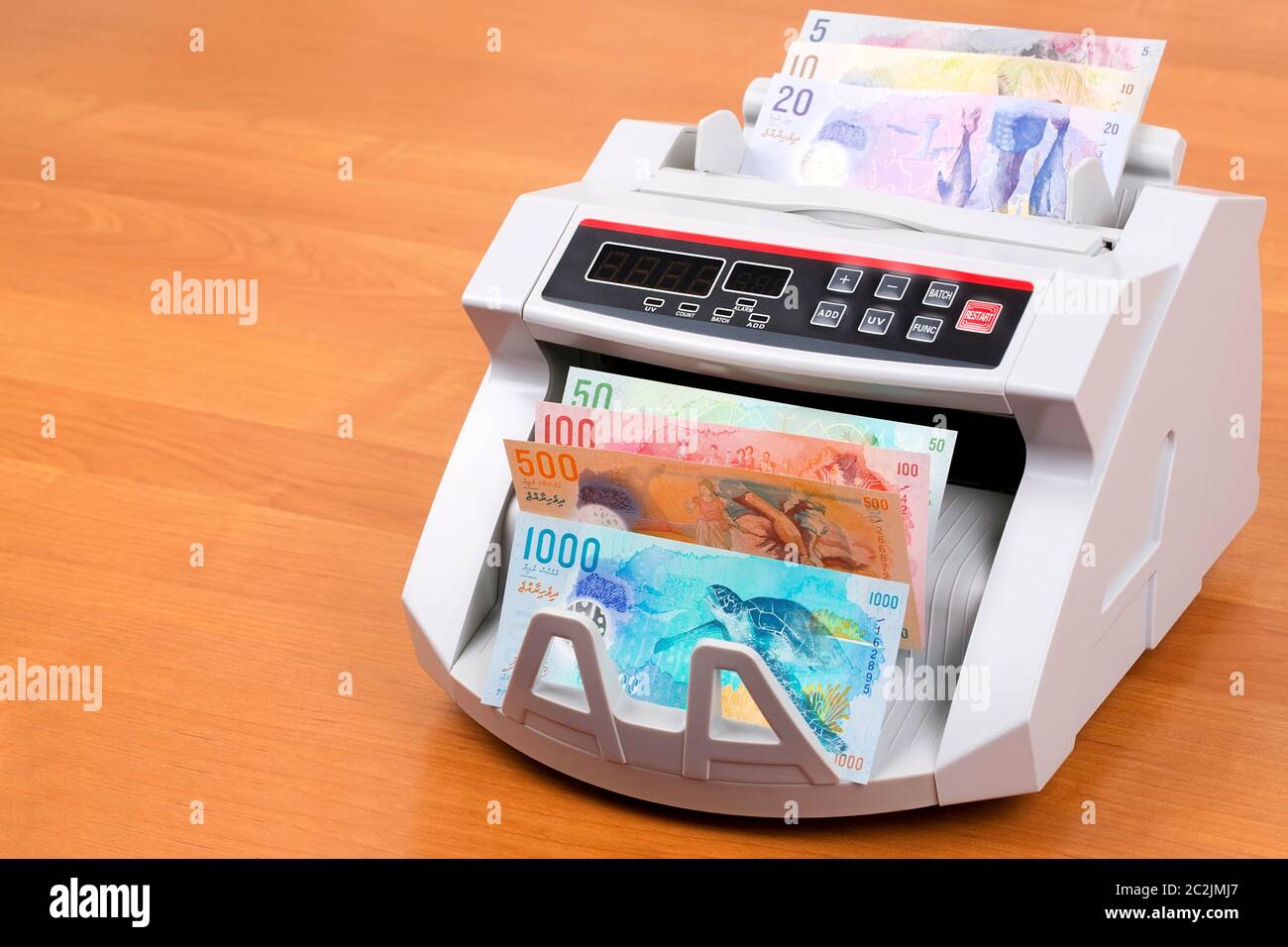 Maldivian Rufiyaa in a counting machine Stock Photo