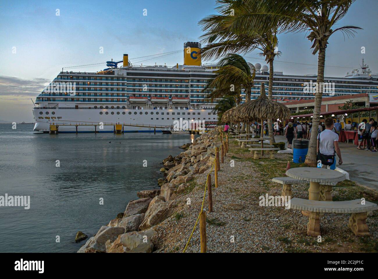 View of the cruise pier full of tourists with the cuise ship in the
