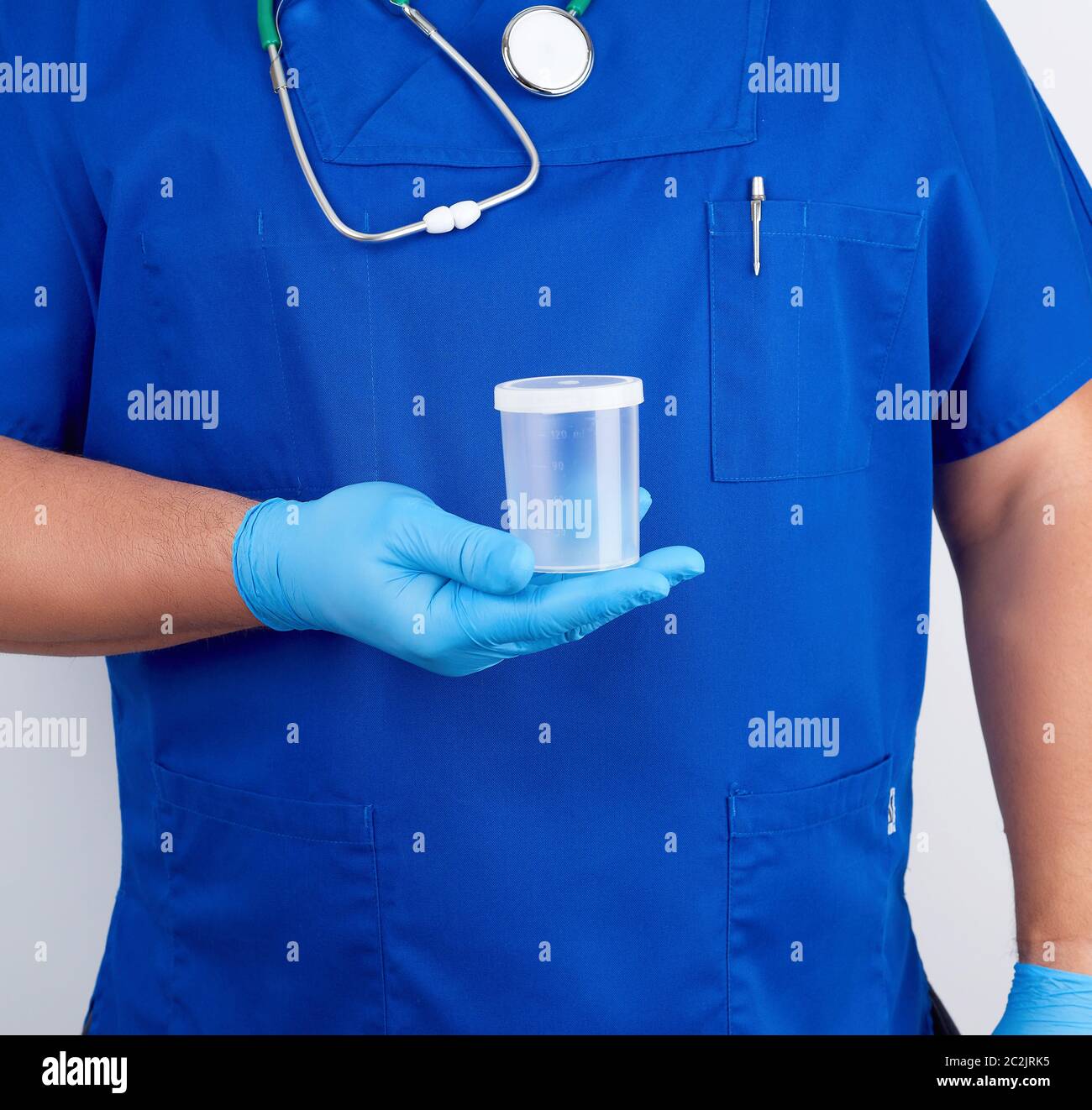 doctor in blue uniform and latex gloves is holding an empty plastic ...
