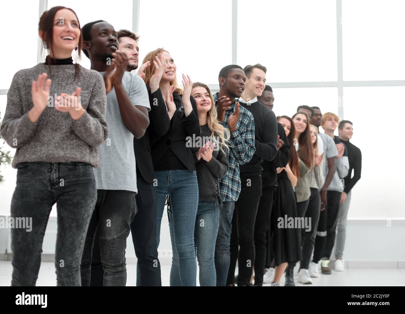 group of diverse young people applaud standing in a row Stock Photo - Alamy