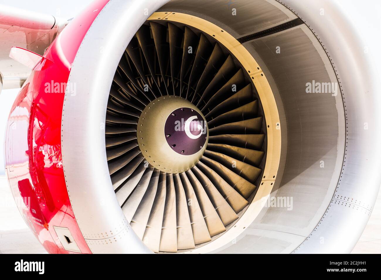 High detailed closeup view on jet airplane engine with red cowling and white background Stock Photo