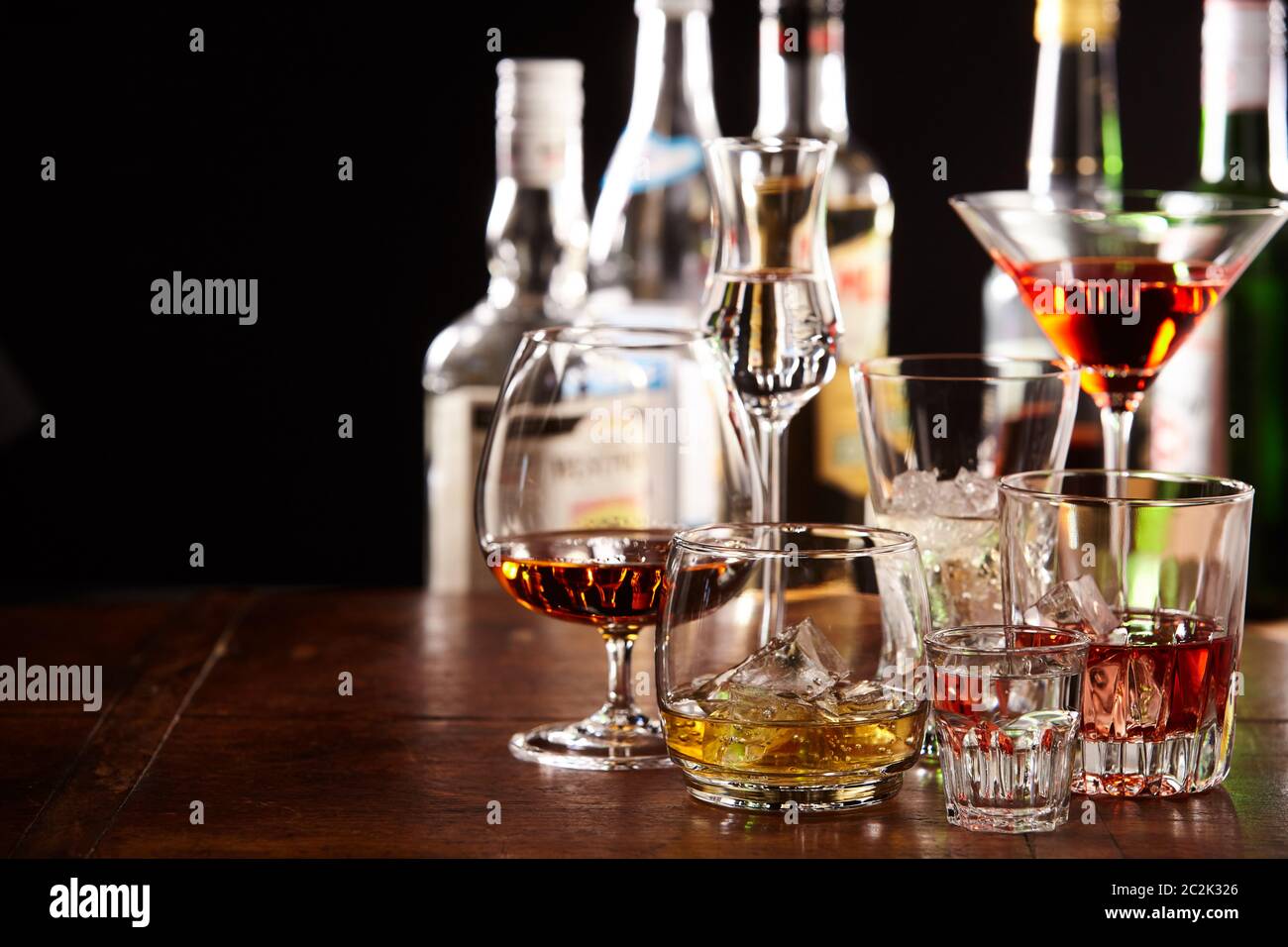 Large assortment of different cocktails in glasses on a bar counter at