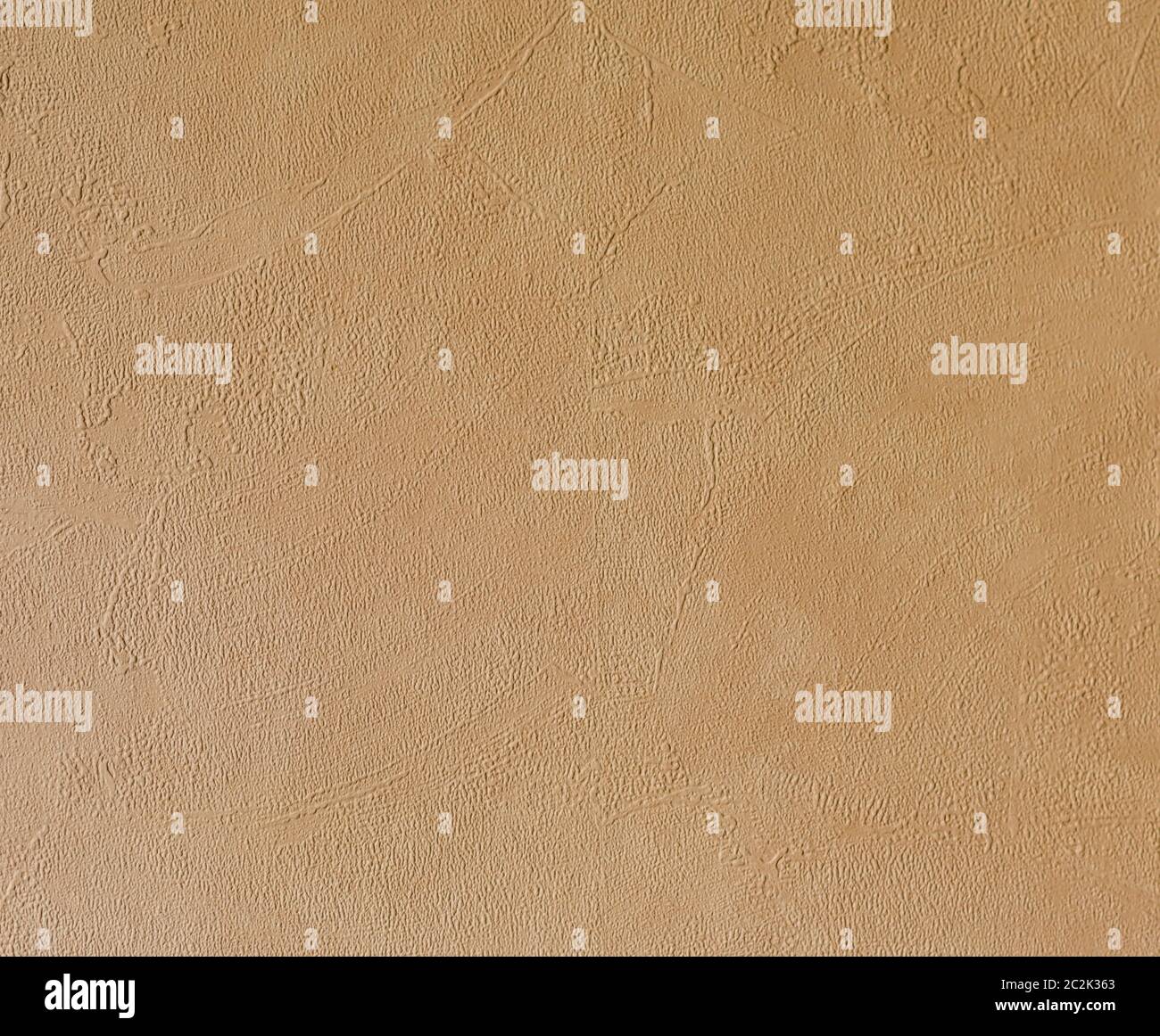 Bright beige rough plastered house wall frame as a background Stock Photo