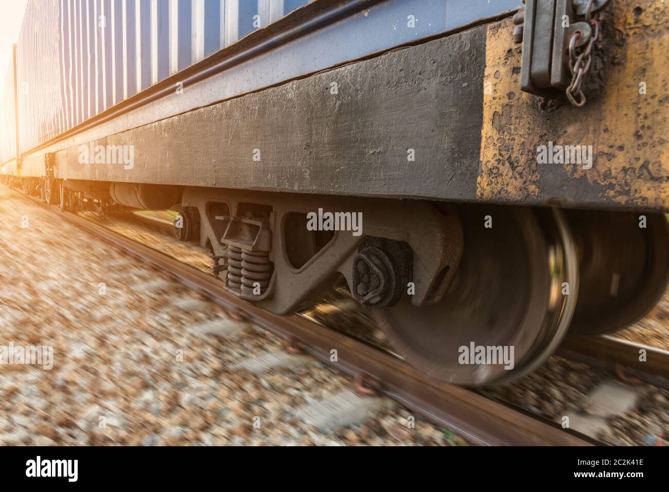 High speed diesel train on tracks with motion blur at sunset Stock Photo