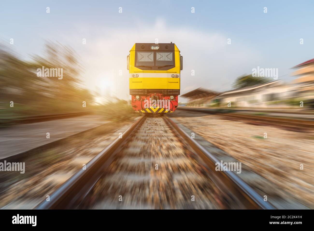 High speed diesel train on tracks with motion blur at sunset Stock Photo