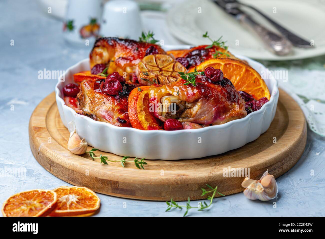 Chicken thighs baked with orange and cherry Stock Photo - Alamy