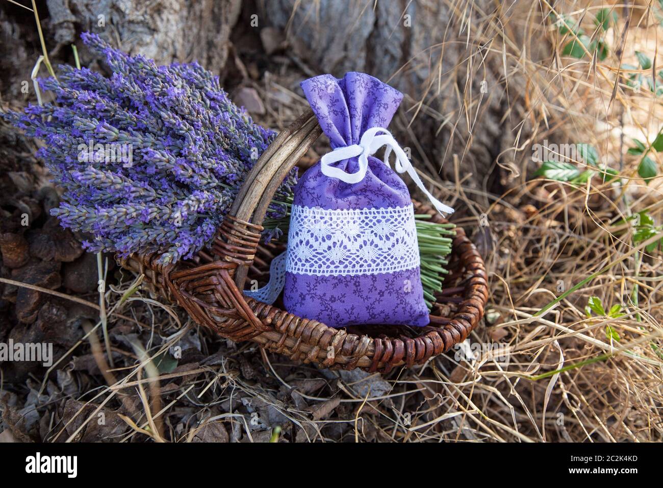 decorative bundle of lavender and bag with dry lavender flowers in rustic wicker basket in the south of France Stock Photo