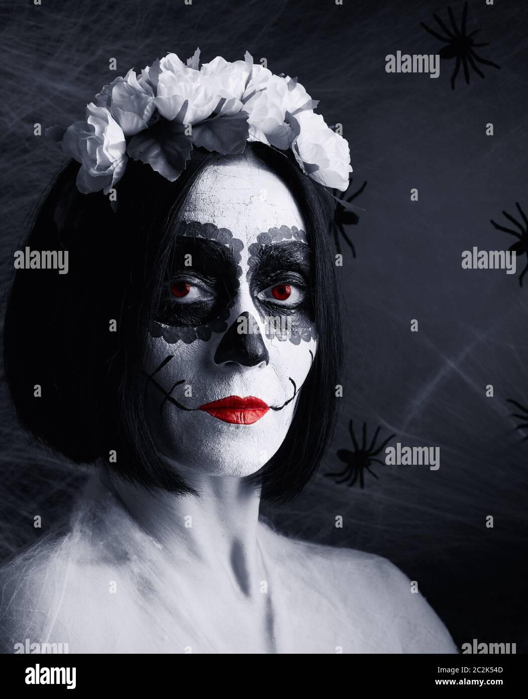 Young beautiful girl with traditional mexican death mask. Calavera