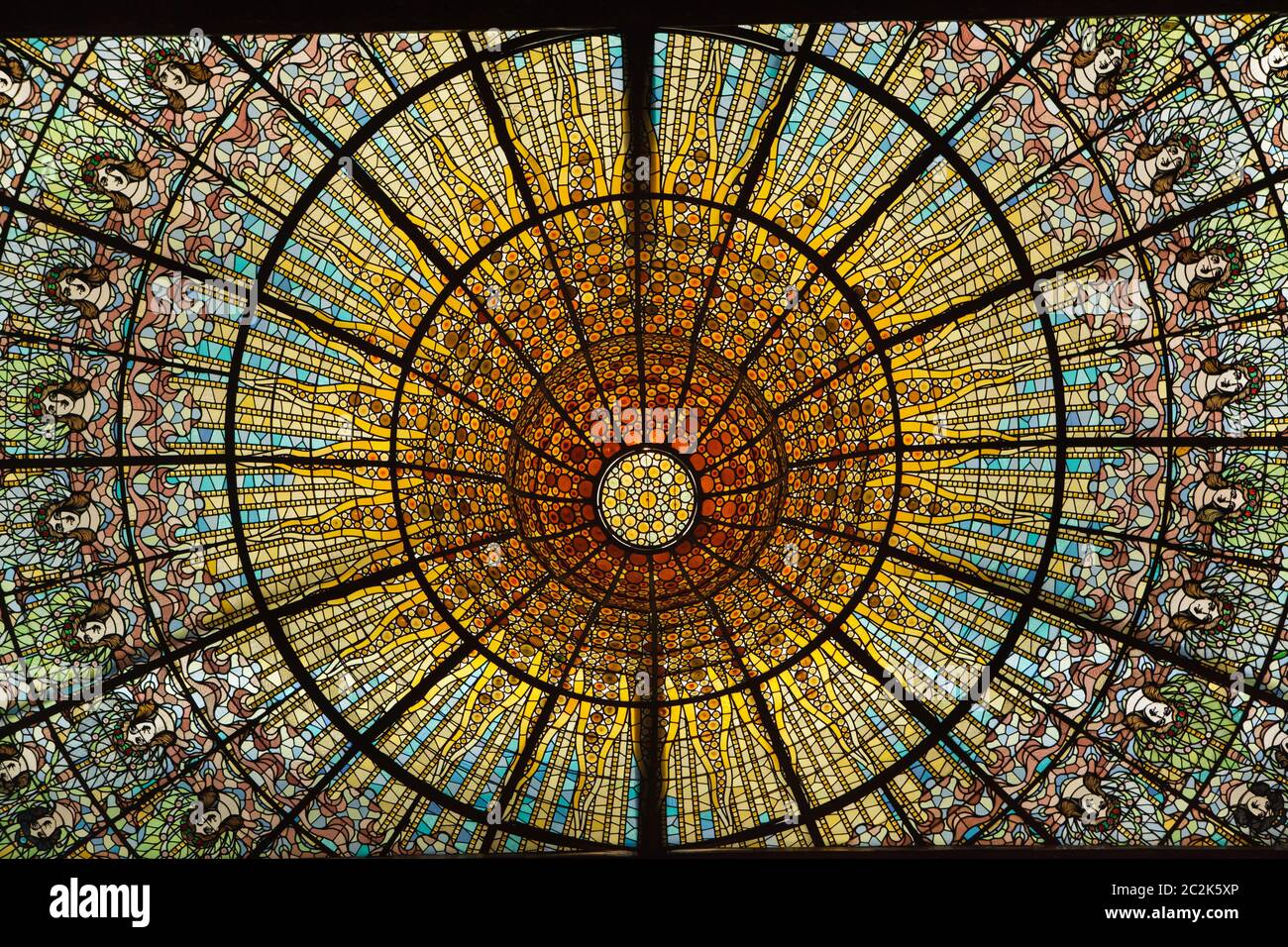Stained-glass skylight in the main concert hall of the Palace of Catalan Music (Palau de la Música Catalana) in Barcelona, Catalonia, Spain. The concert hall designed by Catalan modernist architect Lluís Domènech i Montaner was constructed between 1902 and 1906. The enormous stained-glass skylight was designed by Catalan modernist artist Antoni Rigalt i Blanch. Stock Photo