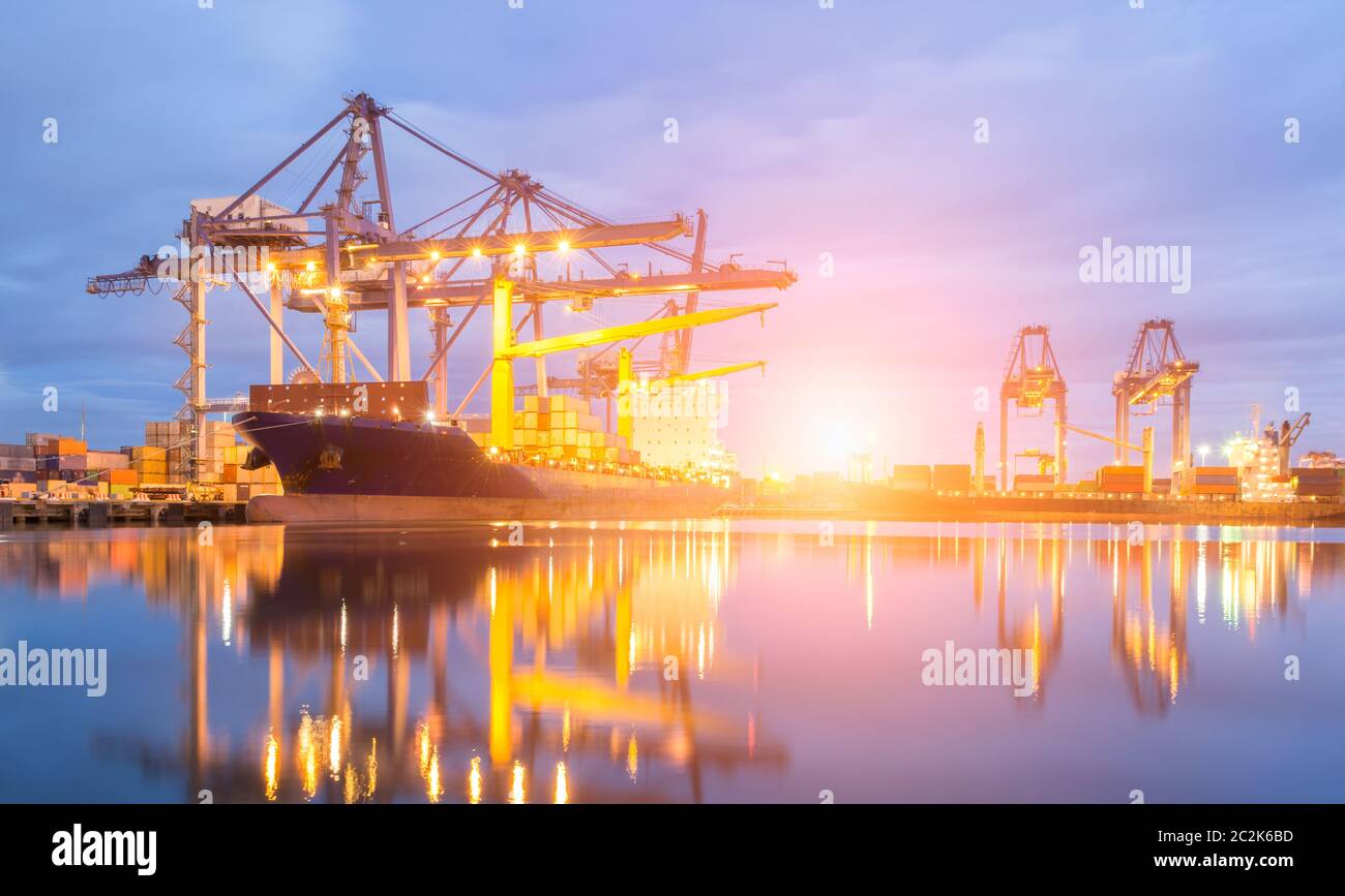 Containers loading by crane at dark sunset, Shipping Trade Port Stock ...