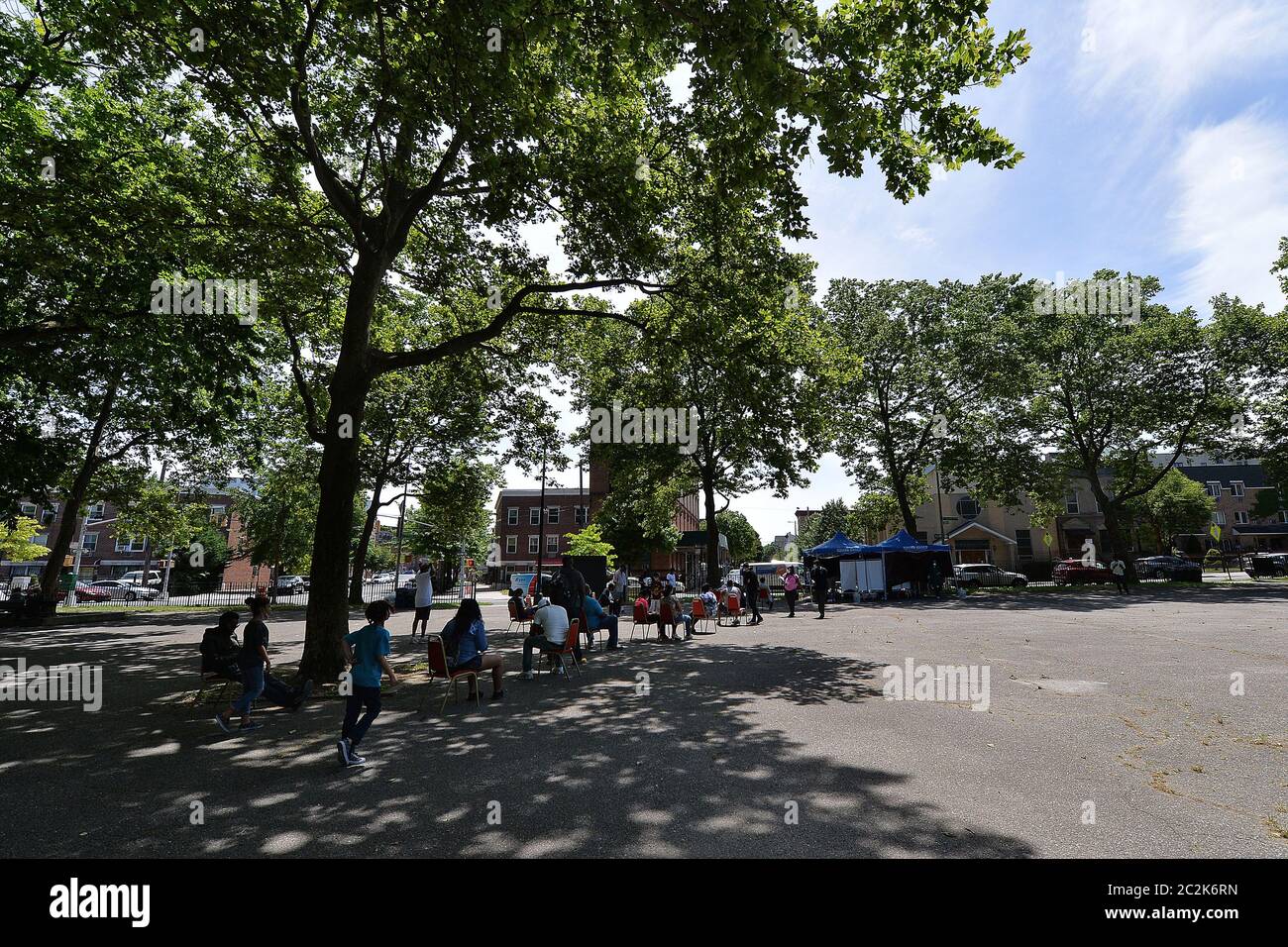 New York City, USA. 17th June, 2020. Practicing social distancing, people wait in chairs for their turn to recieve free COVID-19 testing at the Clinton playground in the Bronx borough of New York, NY, June 17, 2020. Under New York City Mayor Bill de Blasio, the city is expanding its testing sites citywide and opening mobile units to provide free COVID-19 testing to anyone. (Anthony Behar/Sipa USA) Credit: Sipa USA/Alamy Live News Stock Photo