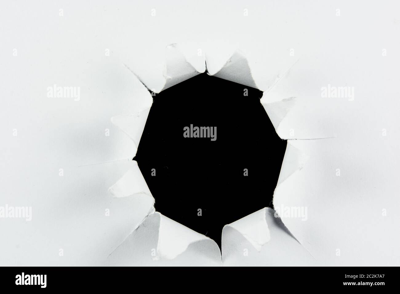 Breakthrough torn big black hole in white paper isolated background ...