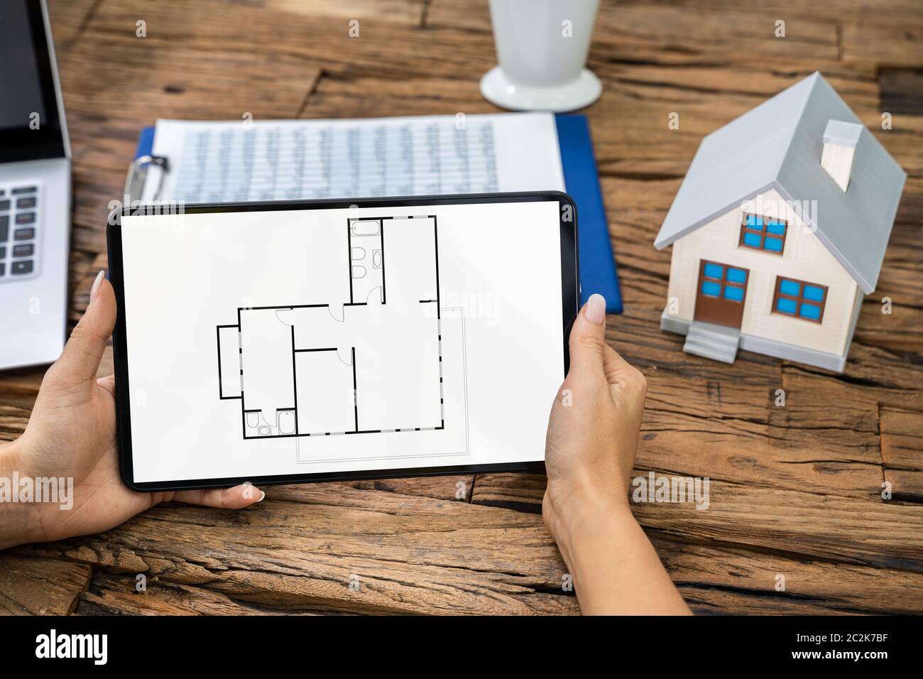 Architect Analyzing House Floor Plan On Digital Tablet Stock Photo