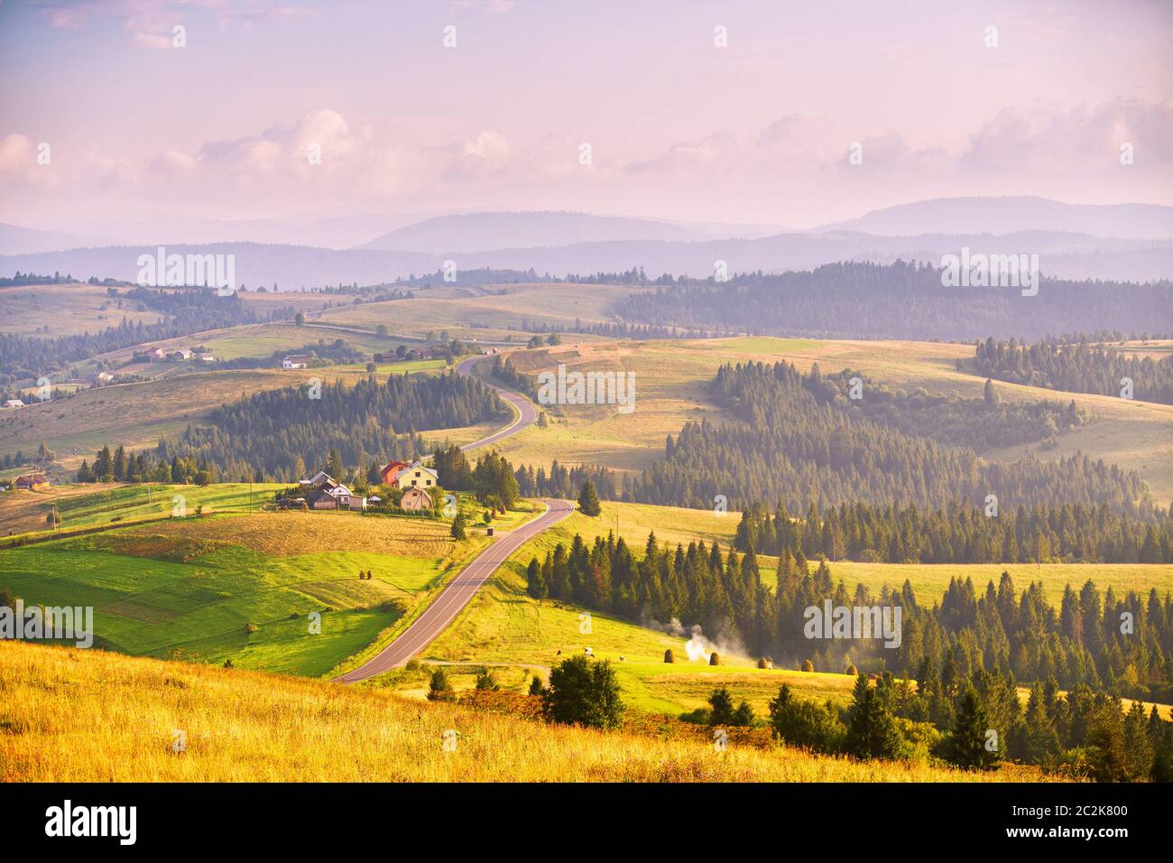 Mountain road at summer sunset. Curved asphalt road on top of the hills. Pieniny and  Beskidy range Stock Photo