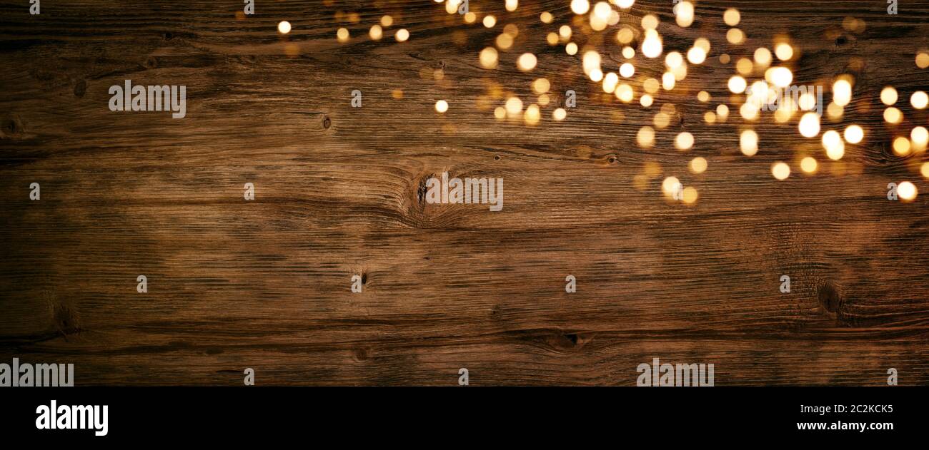 Golden shiny christmas lights on old wood wall Stock Photo - Alamy