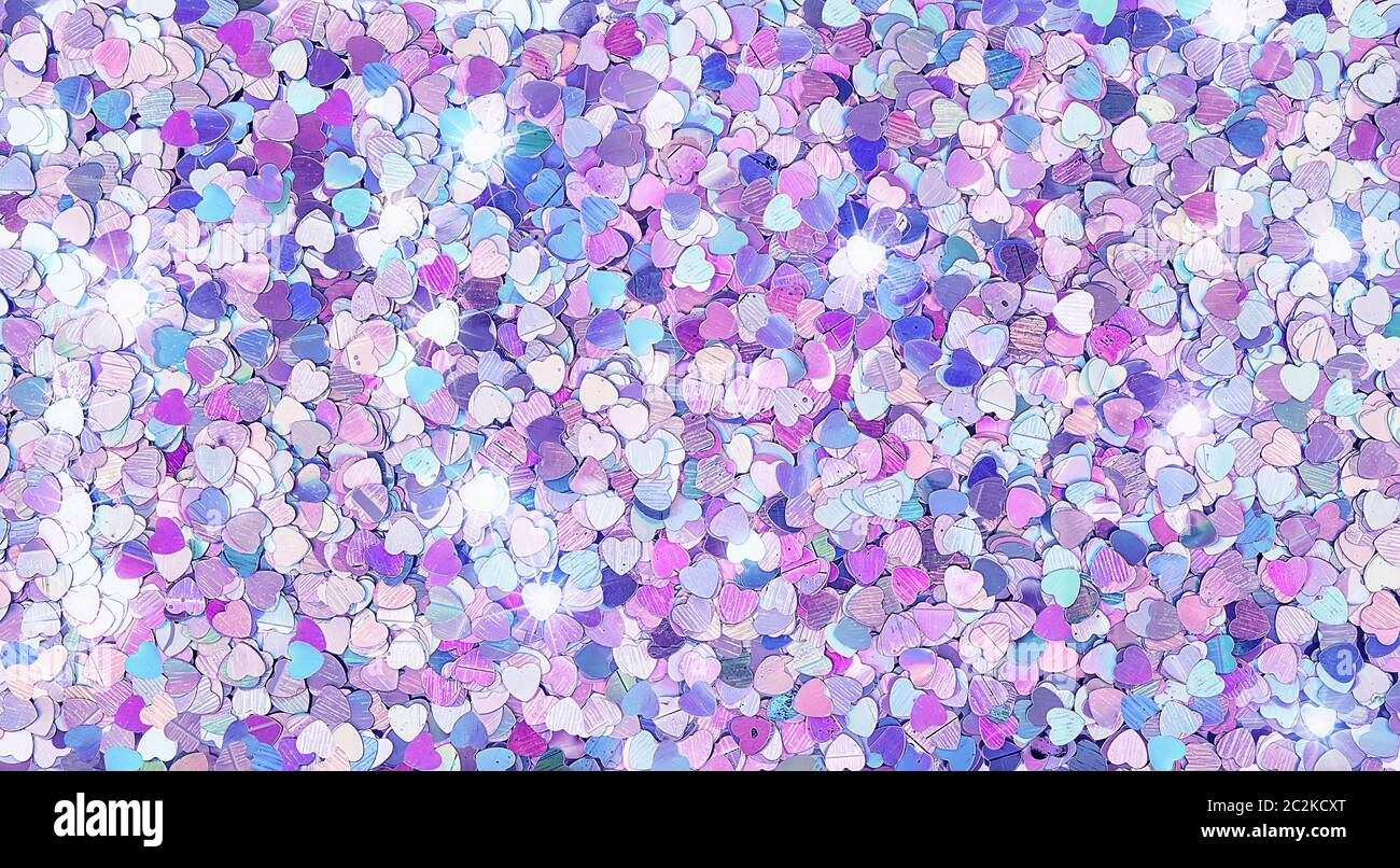Real shiny heart-shaped sparkles textured background Stock Photo