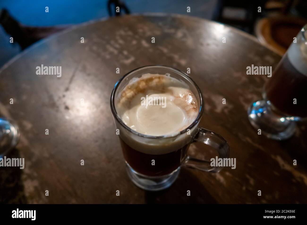 Pint of dark beer on a old wooden table an irish pub Stock Photo