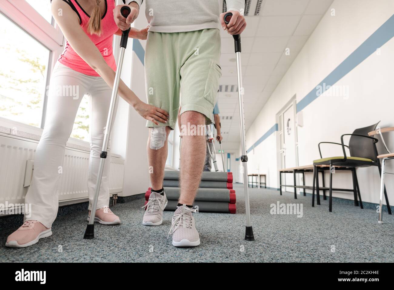 People in rehabilitation learning how to walk with crutches after