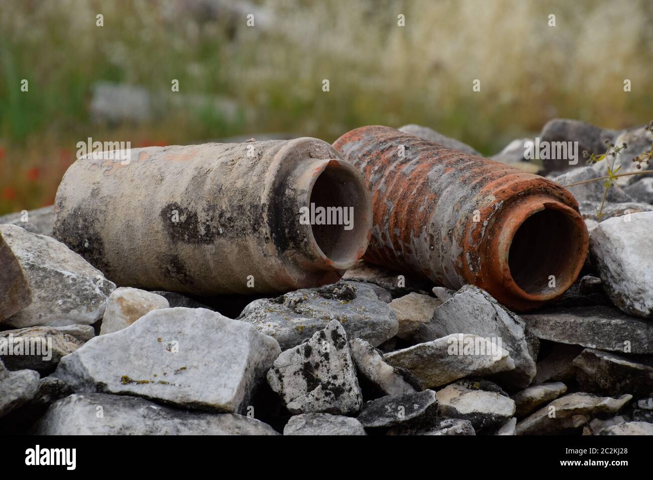 The remains of ancient ceramic pipes from the water supply. Prefabricated sections of ceramics from which the pipeline was assembled. Stock Photo