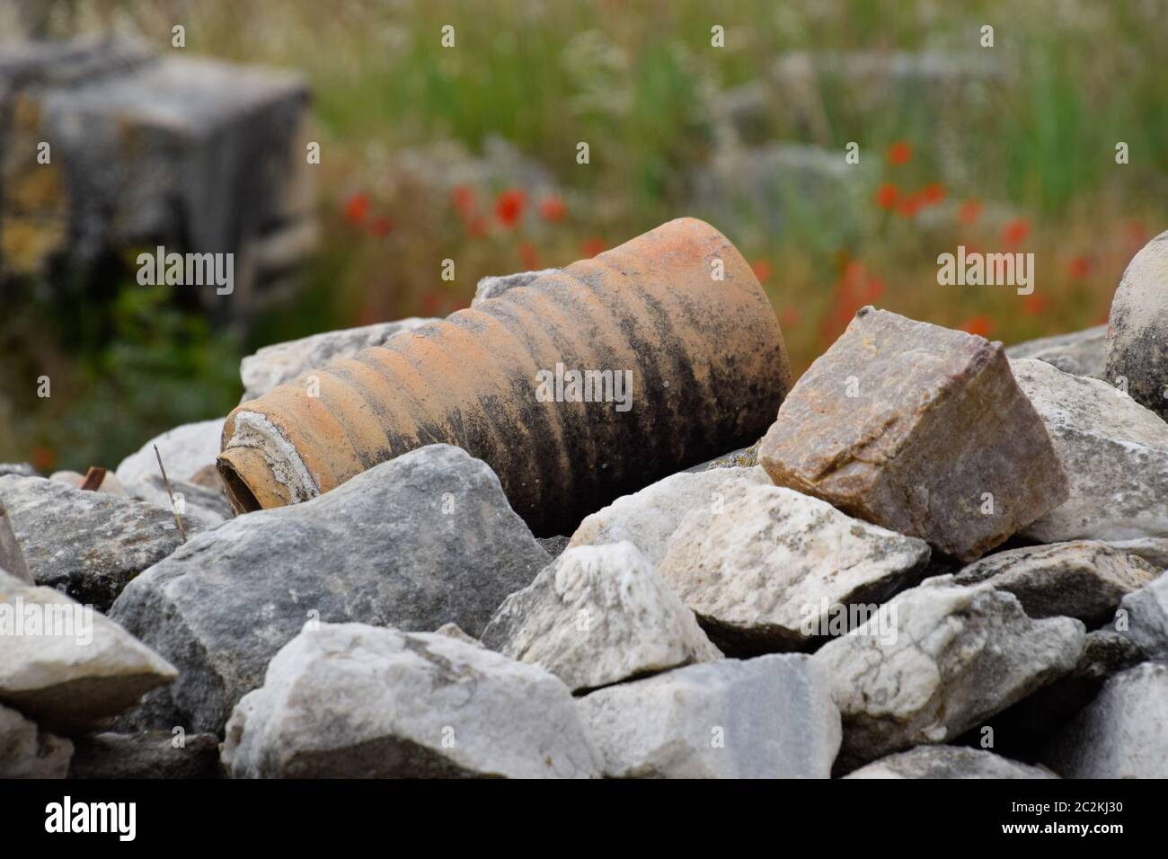 The remains of ancient ceramic pipes from the water supply. Prefabricated sections of ceramics from which the pipeline was assembled. Stock Photo