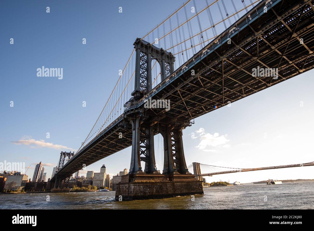 Manhattan Bridge in daylight view from Lower East Side waterfront Stock Photo