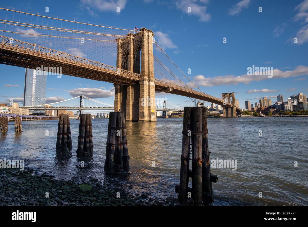 Brooklyn Bridge in daylight view from Lower East Side waterfront Stock Photo