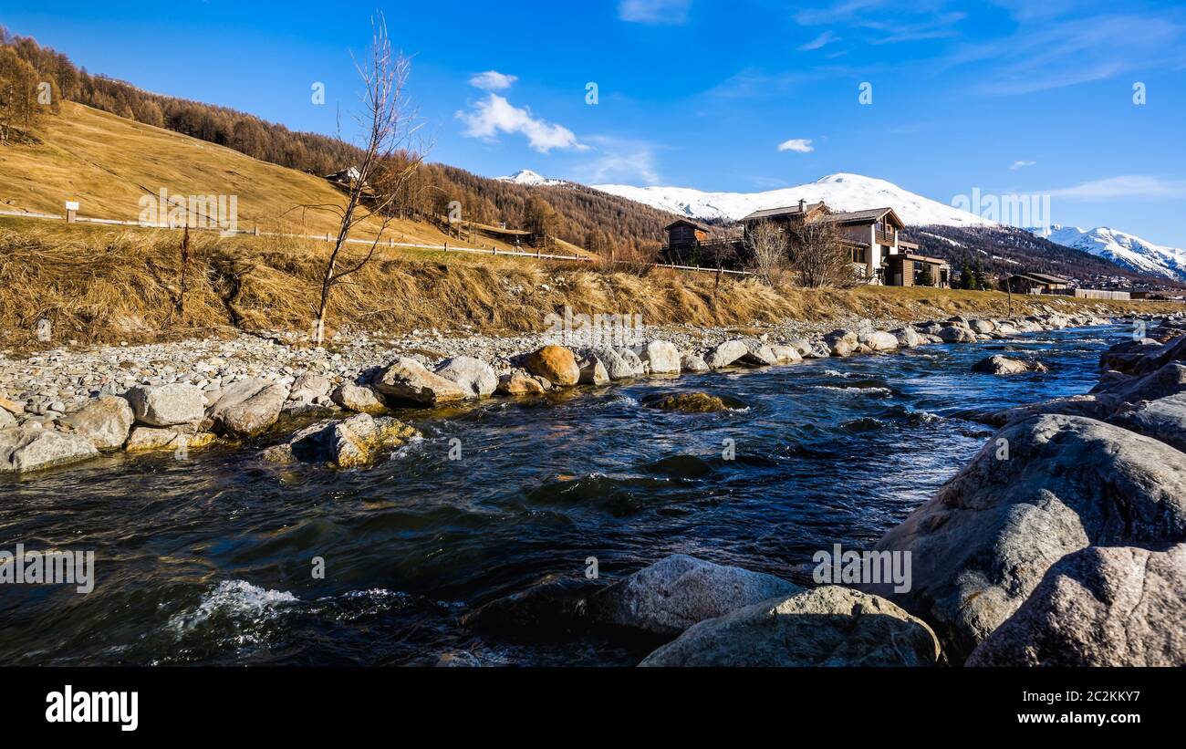 https://c8.alamy.com/comp/2C2KKY7/beautiful-mountain-valley-with-stream-trees-wooden-fence-and-footpath-livingo-village-in-background-italy-alps-2C2KKY7.jpg