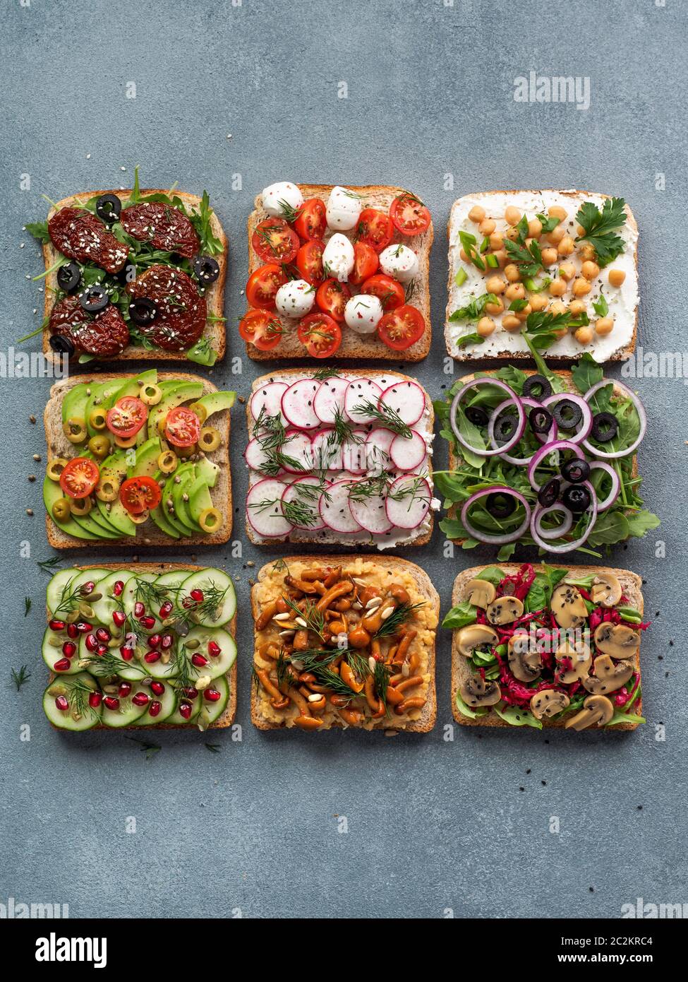 Assortment vegan sandwiches on gray stone background Stock Photo