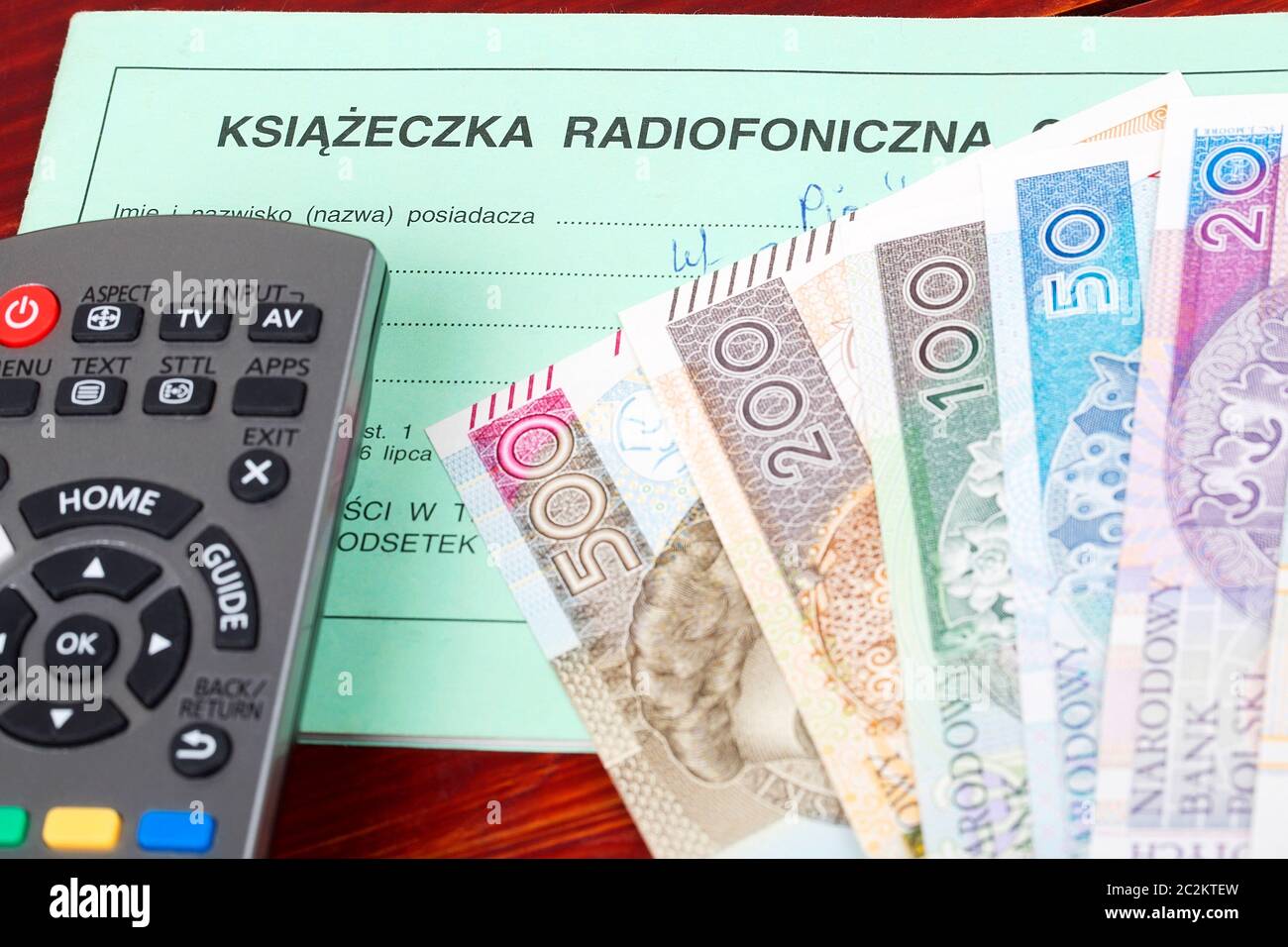 Polish TV subscription booklet with a remote control and money Stock Photo