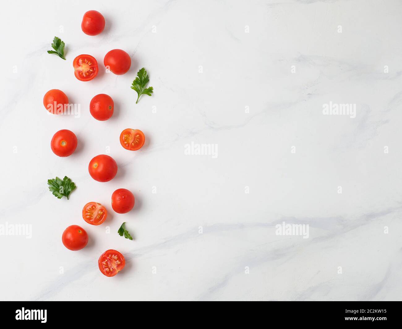 Cherry tomatoes on white marble table Stock Photo